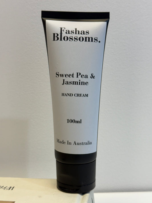 Hand cream tube labeled 'Fashas Blossoms Sweet Pea & Jasmine' on a neutral background