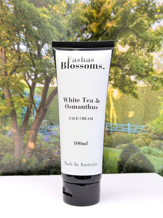 Tube of Fashas Blossoms White Tea & Osmanthus Face Cream with a garden background