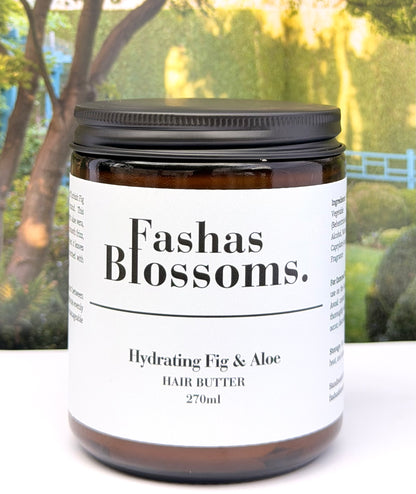 Jar of Fashas Blossoms hydrating fig & aloe hair butter with a blurred outdoor background
