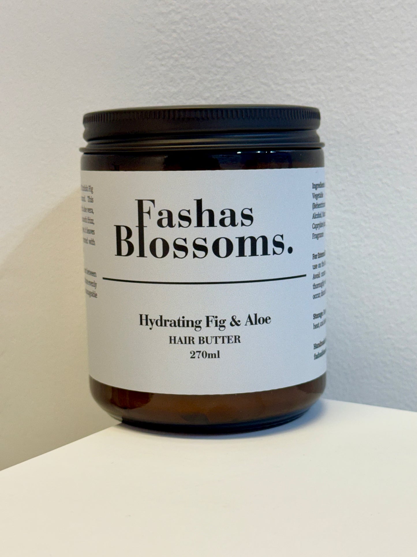 Jar of Fashas Blossoms hydrating fig & aloe hair butter on a white surface with a light gray background