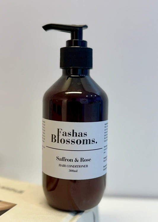 Brown bottle of Fashas Blossoms Saffron & Rose hair conditioner on a light background