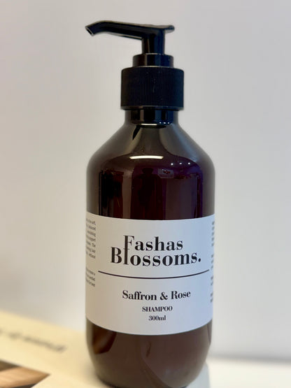 Brown shampoo bottle with pump labeled 'Fashas Blossoms Saffron & Rose' on a white background