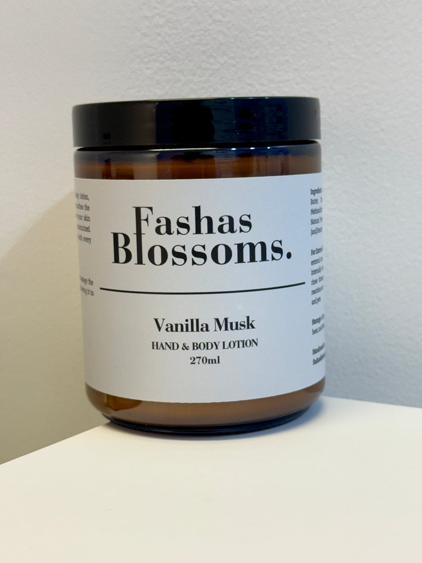Jar of Fashas Blossoms Vanilla Musk hand and body lotion on a white surface with a light gray background