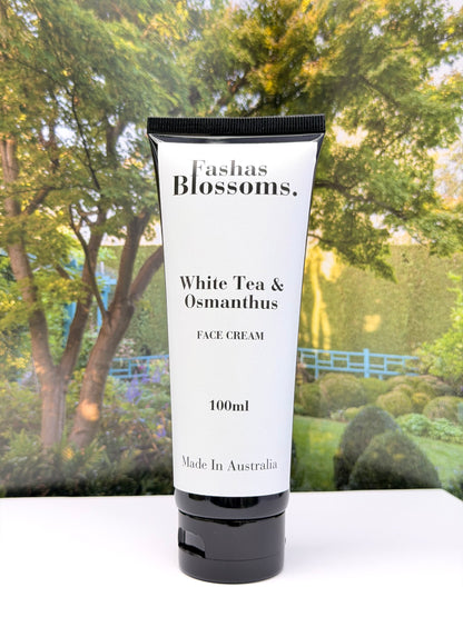 Tube of Fashas Blossoms White Tea & Osmanthus Face Cream with a garden background