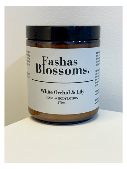Hand and body lotion jar labeled 'Fashas Blossoms' with 'White Orchid & Lily' scent on a white background.