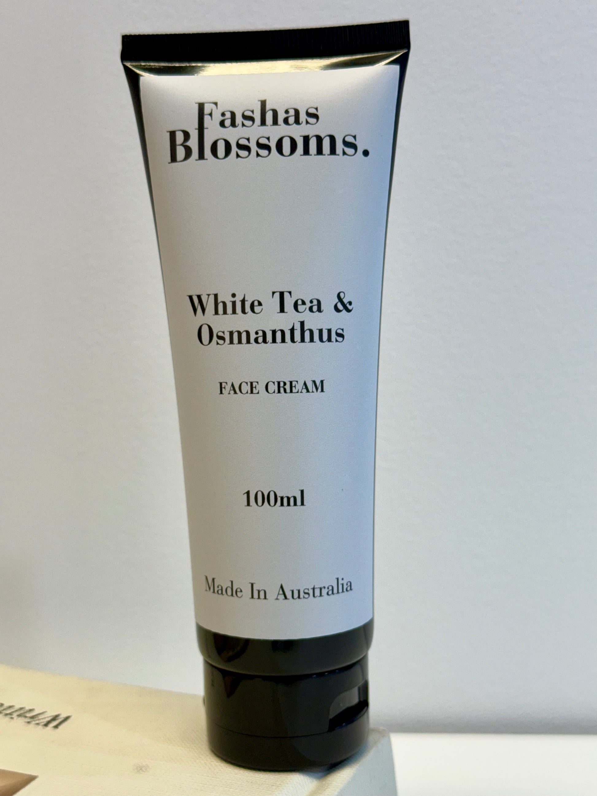 Tube of Fashas Blossoms White Tea & Osmanthus Face Cream on a light gray background